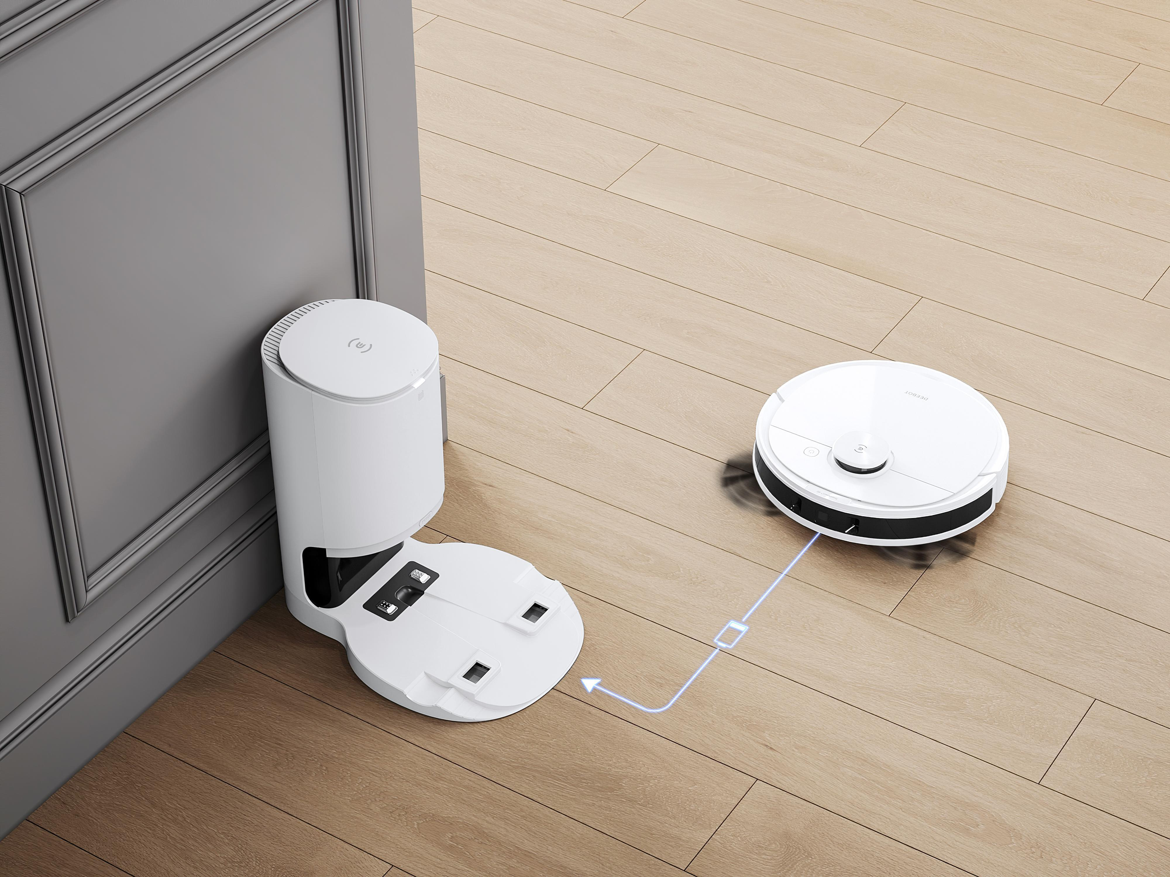 Ein weißer Roboter-Staubsauger und eine Ladestation.