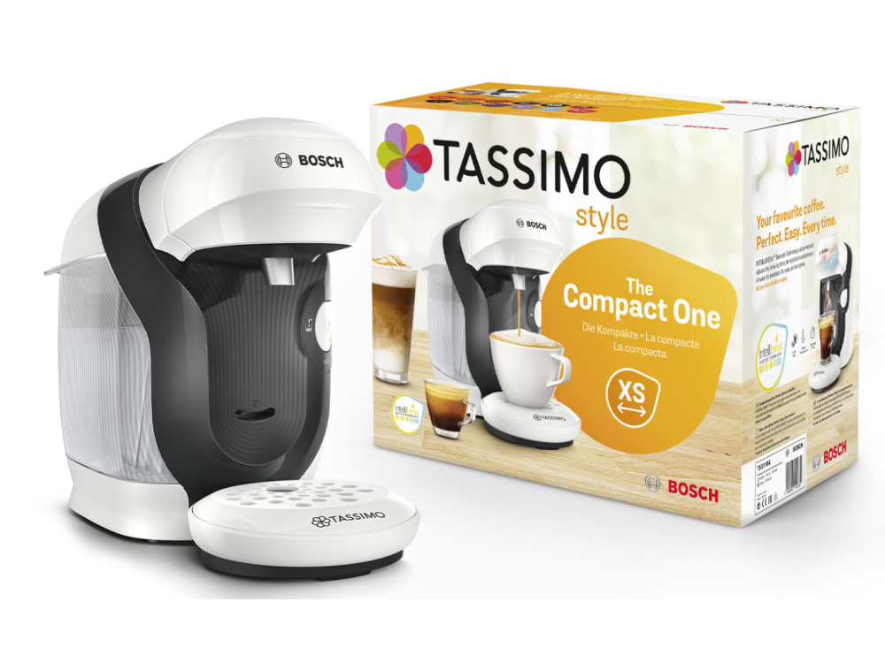 Una cafetera Tassimo blanca y negra y su caja sobre un fondo blanco.