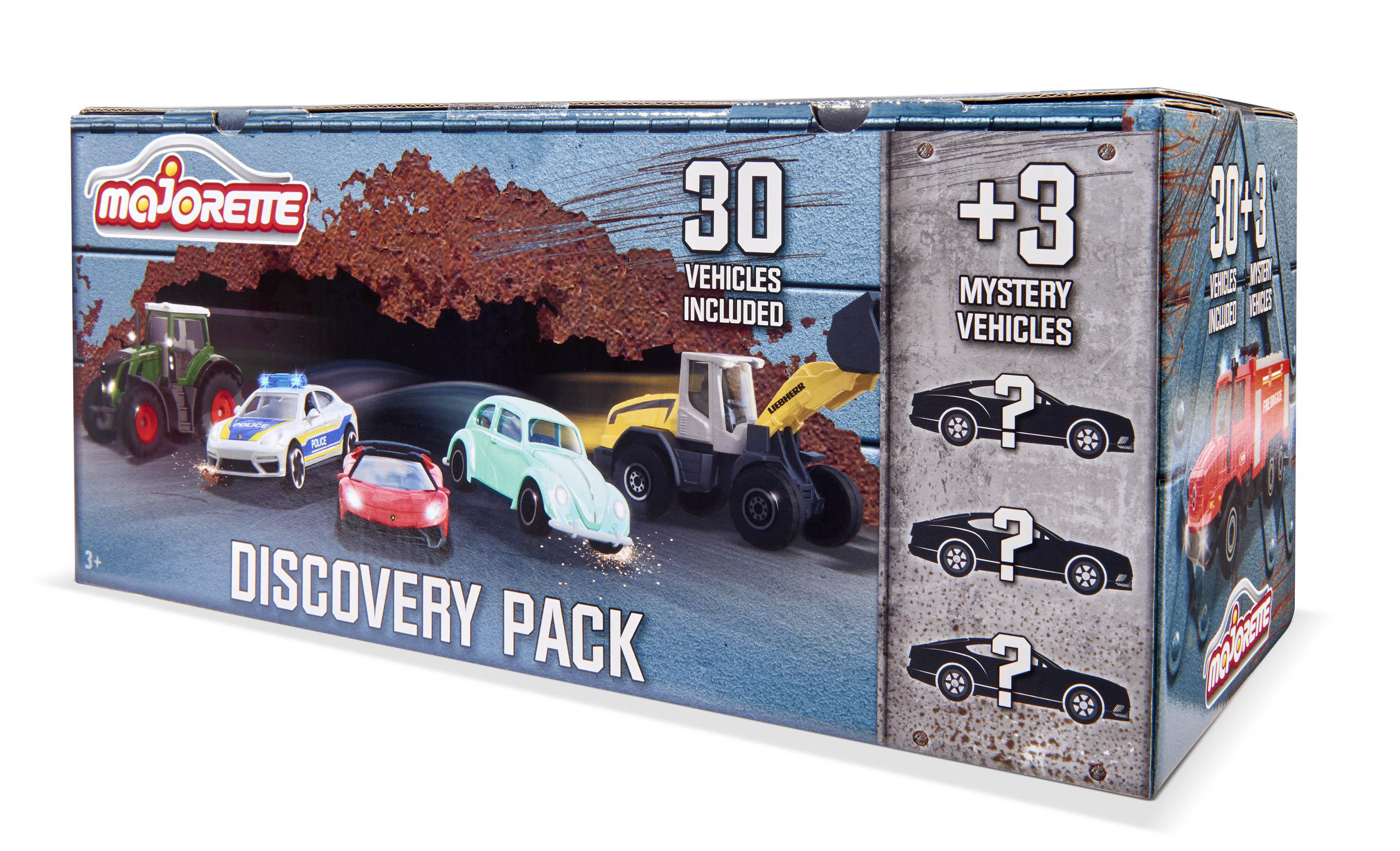 Auf der Abbildung ist eine Majorette Discovery Pack-Box mit Spielzeugautos und den Worten '30 Fahrzeuge enthalten' und '+3 Mystery Vehicles' zu sehen.