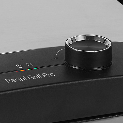 Black panini grill control panel with a rotary dial and indicator lights. The text says 'Panini Grill Pro'.