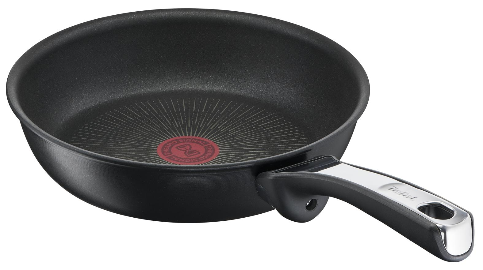 A black frying pan with a red circle in the center and a black and silver handle.