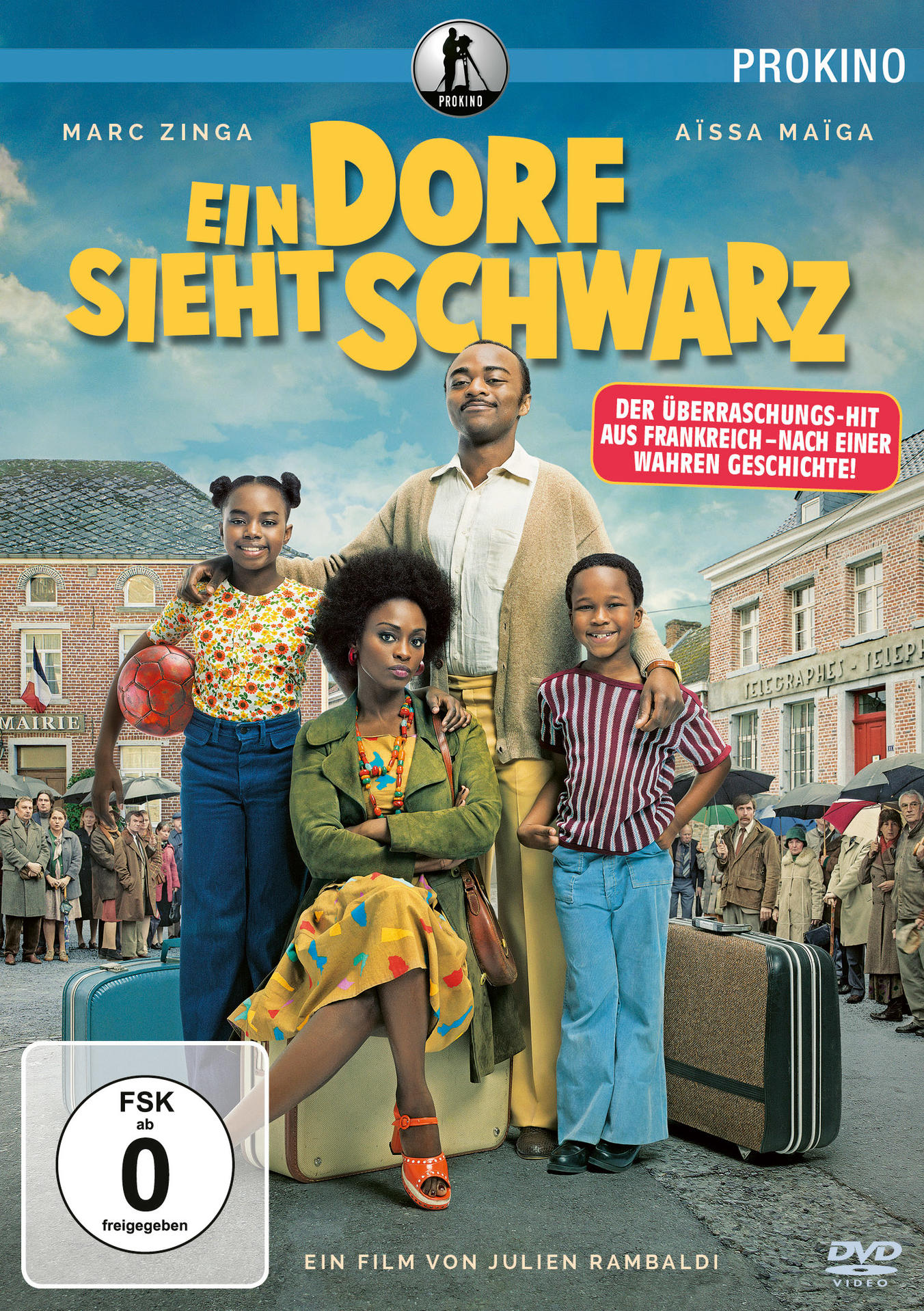 DVD-Cover eines Films mit einer schwarzen Familie. Text auf Französisch 'Ein Dorf sieht Schwarz'.