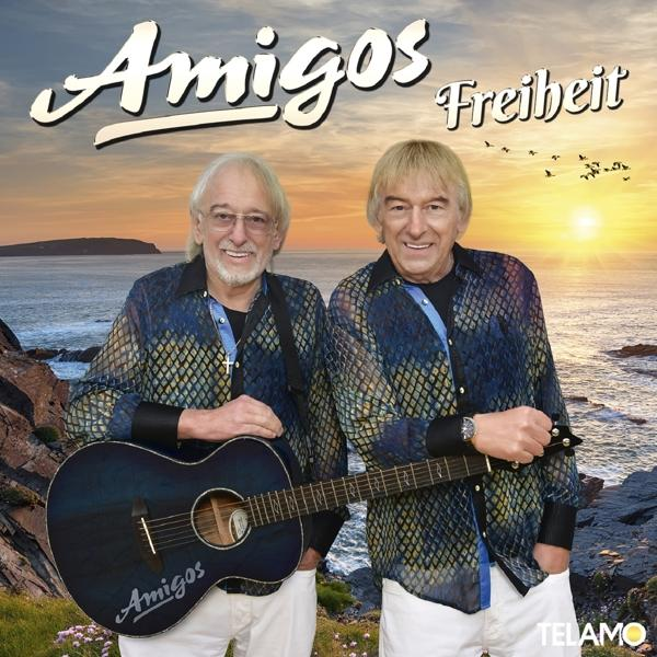Albumcover von „Amigos - Freiheit“ mit zwei Männern, die Gitarren vor Sonnenuntergang halten.