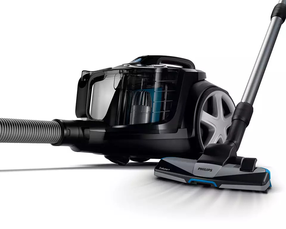 Black and grey Philips vacuum cleaner, angled view. The hose is connected to the left.