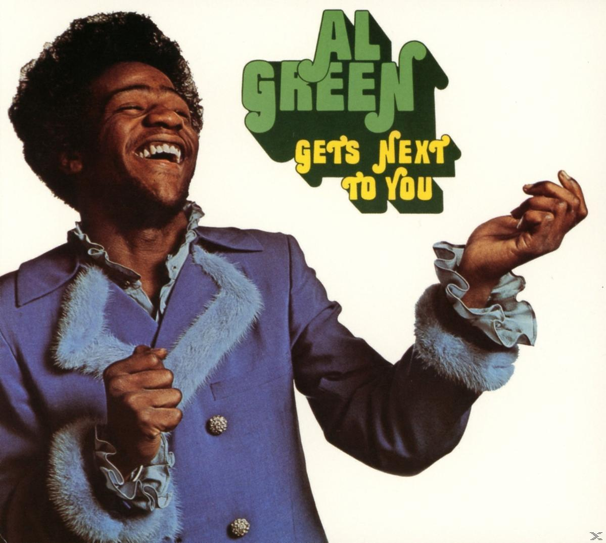 Al Green album borítója. Mosolyog, kék szőrmével szegélyezett kabátot visel, fehér háttérrel.