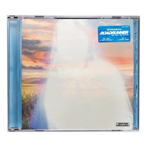 CD-Hülle mit verschwommenem Bild, mit blauem Aufkleber 'Roadrunner' und anderem Text.