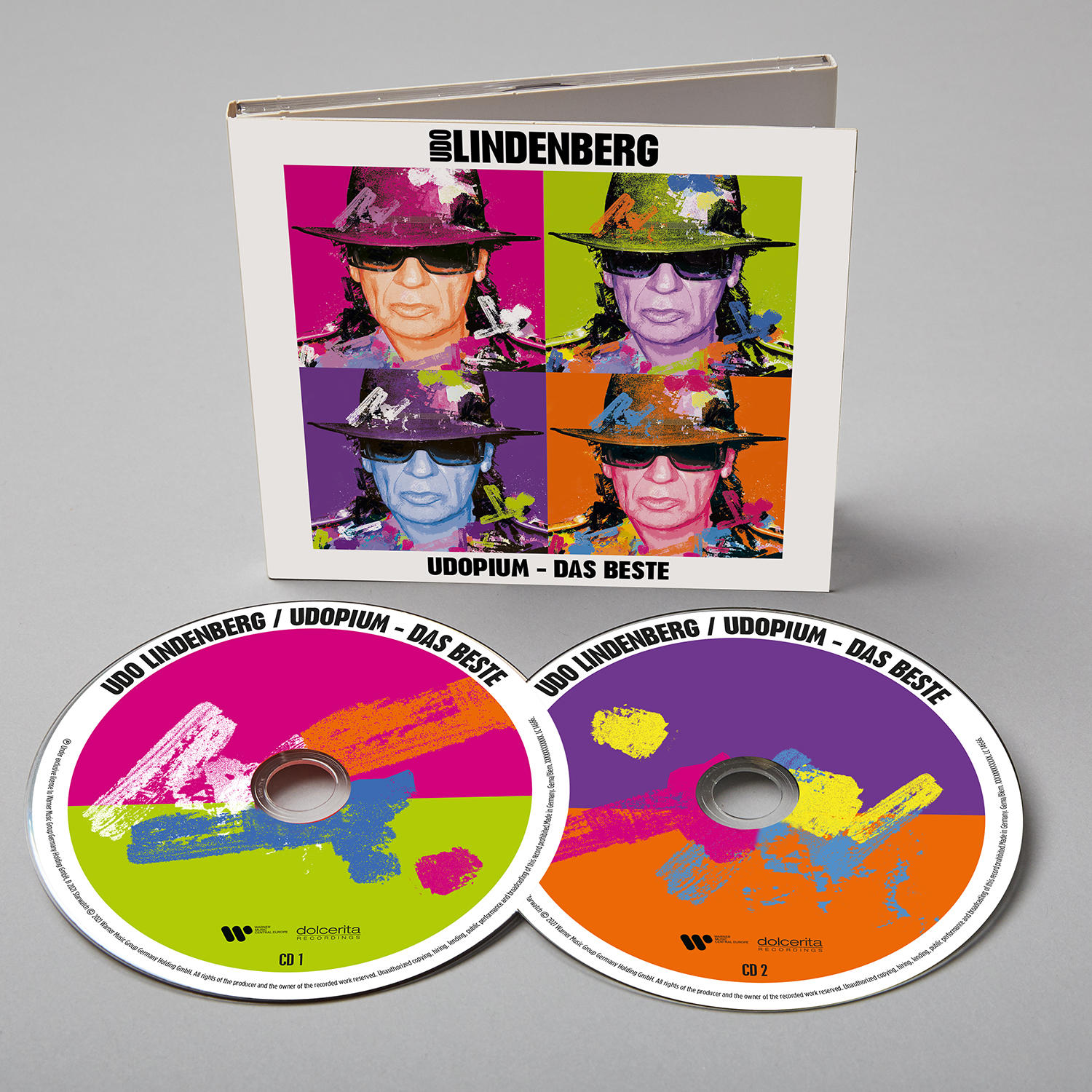 Zwei CDs mit dem Gesicht des Künstlers auf dem Cover, in einem CD-Case, farbenfrohes Design.