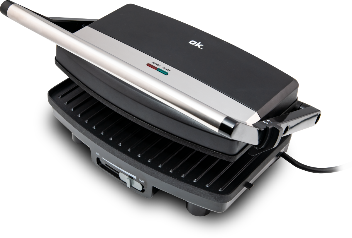 Black and gray panini press. The press is closed and on a black surface.