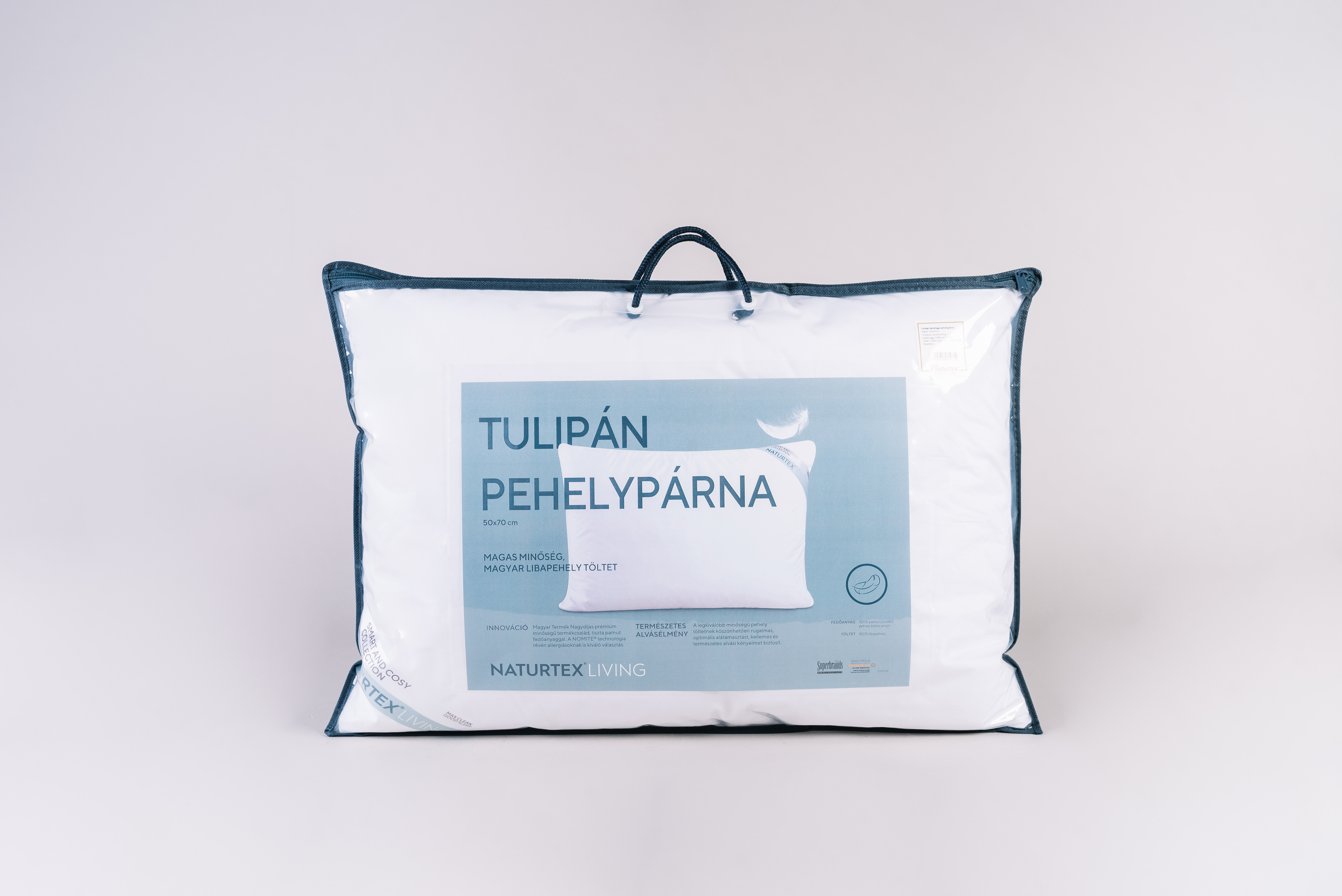 Párna lezárt műanyag zacskóban, fogantyúval. Címke párnaképpel.