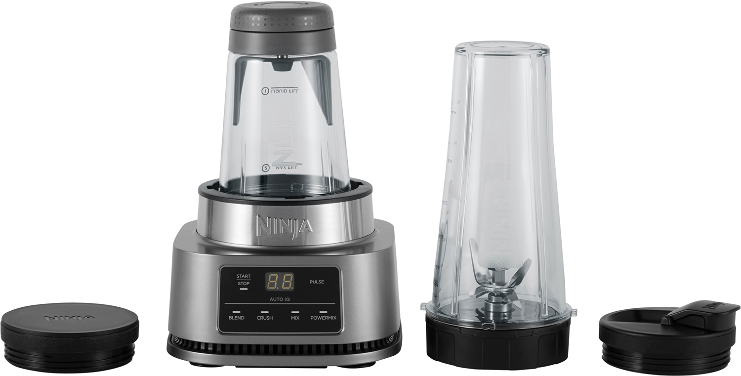 Ninja blender with multiple parts: base, blending container, travel cup, and lids.