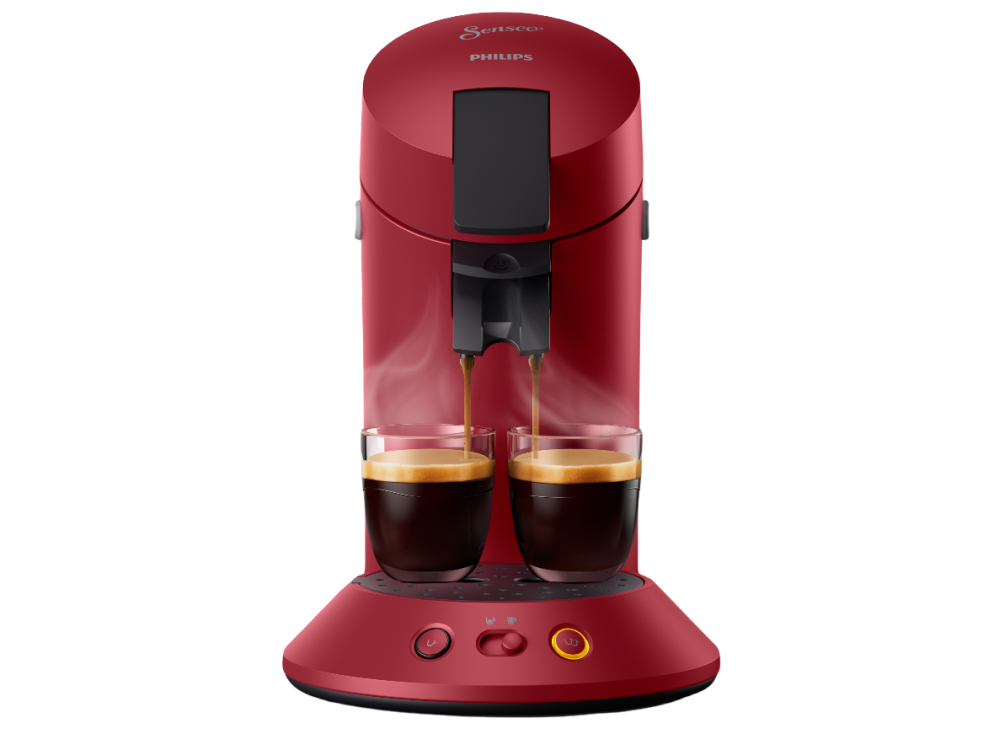 Cafetera Philips Senseo roja con dos vasos y café vertiéndose en ellos.