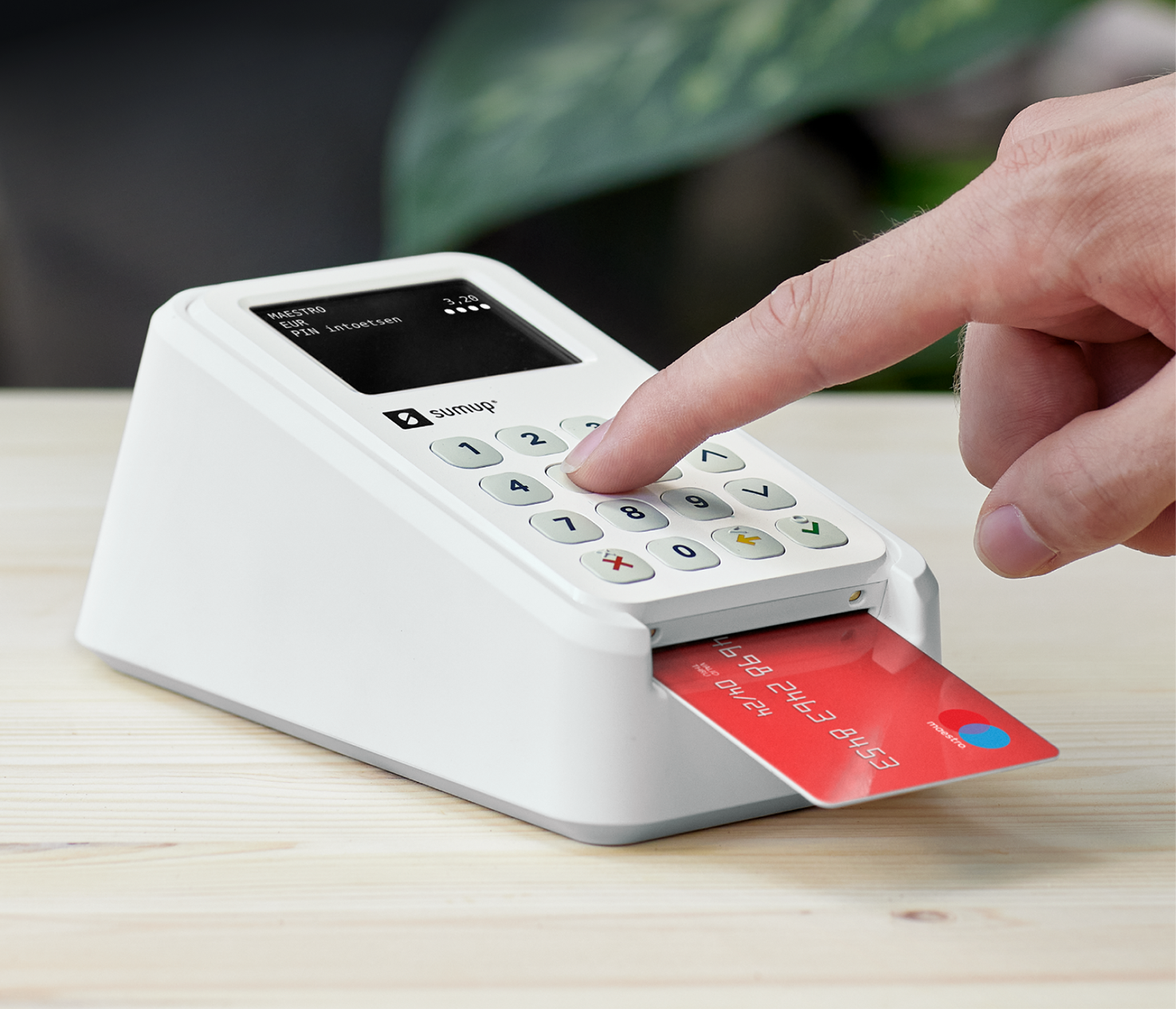 White payment terminal with a red card inserted.