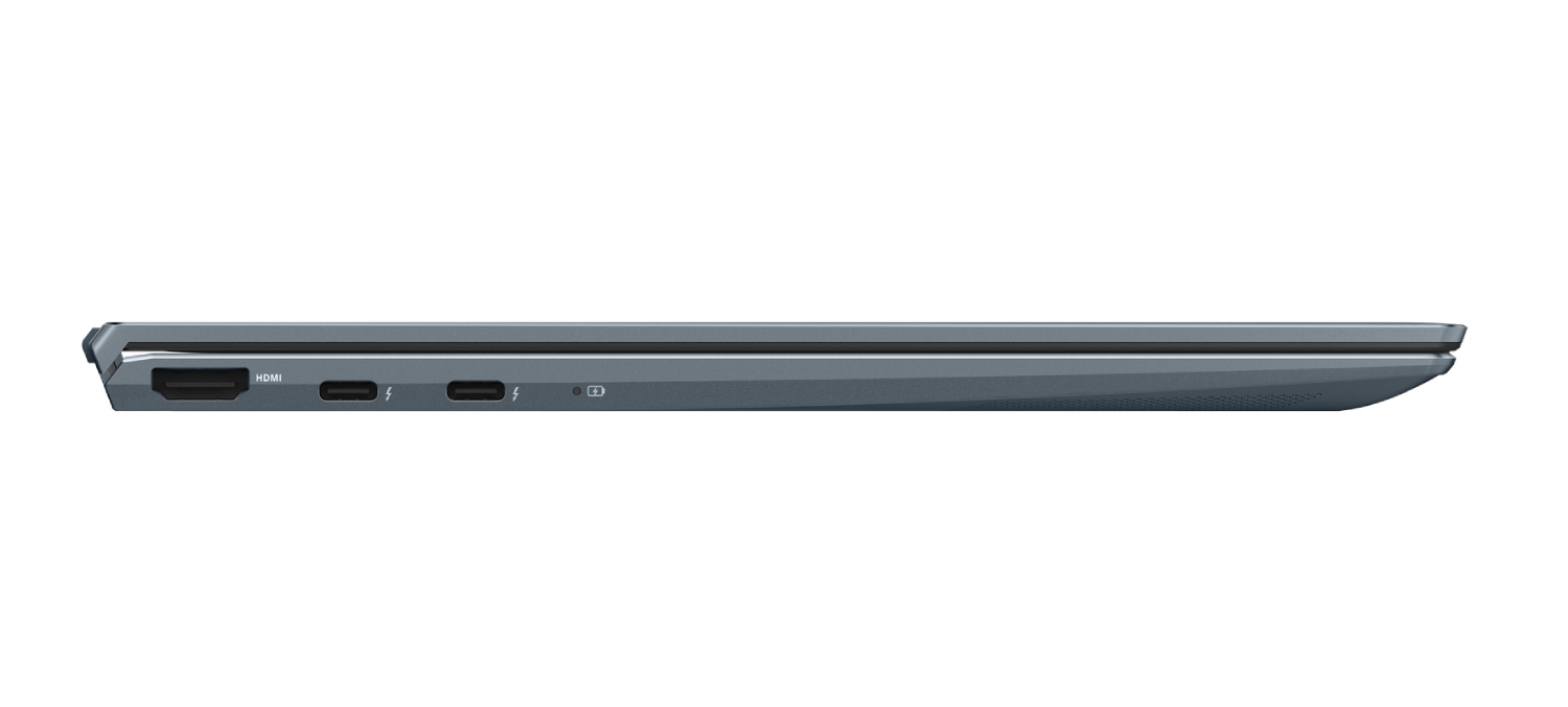 Vista lateral de un portátil gris cerrado. Puertos visibles: HDMI, USB-C y alimentación. Fondo blanco.