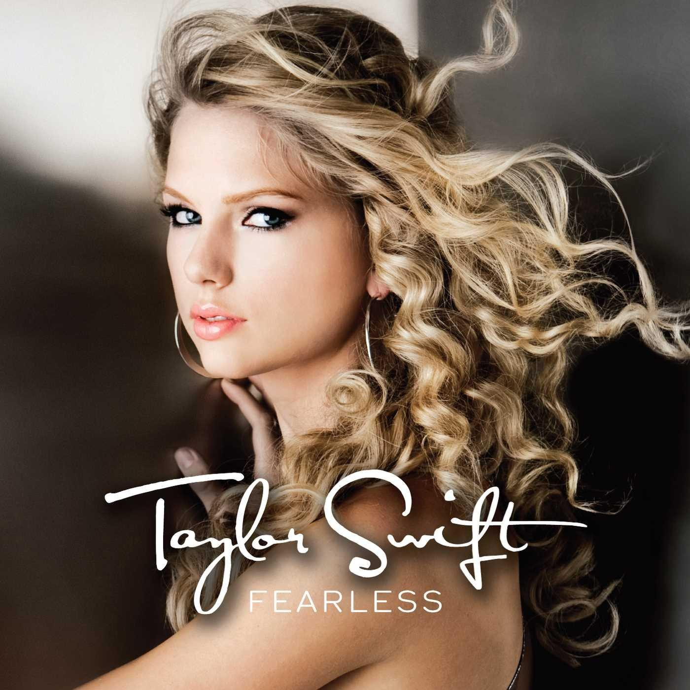 Taylor Swift on the album cover of Fearless. She has blonde hair and is looking at the camera.