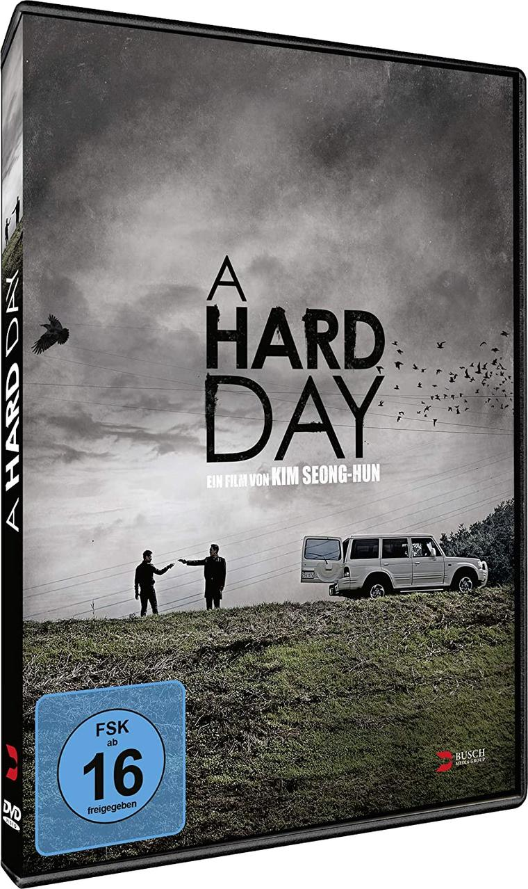 DVD-Cover von A Hard Day. Zwei Männer und ein Auto auf einem Hügel. Himmel mit Vögeln.