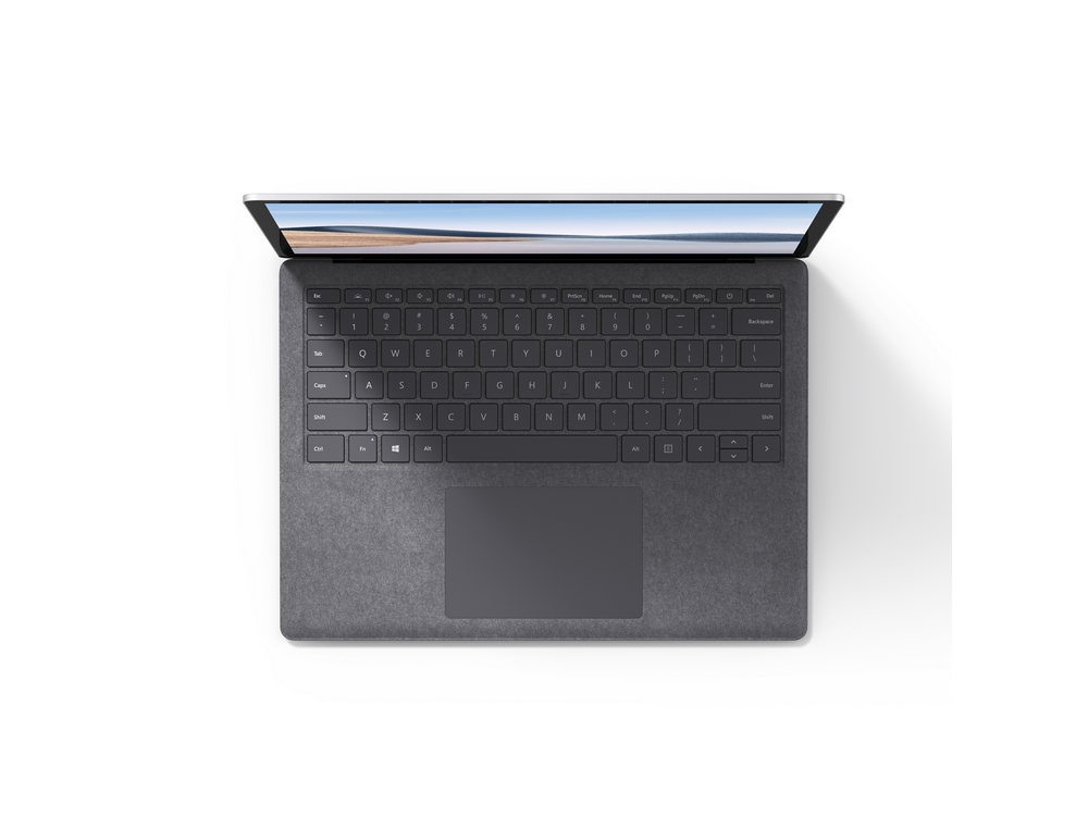 Portátil con pantalla abierta, mostrando teclado y panel táctil, sobre superficie blanca.