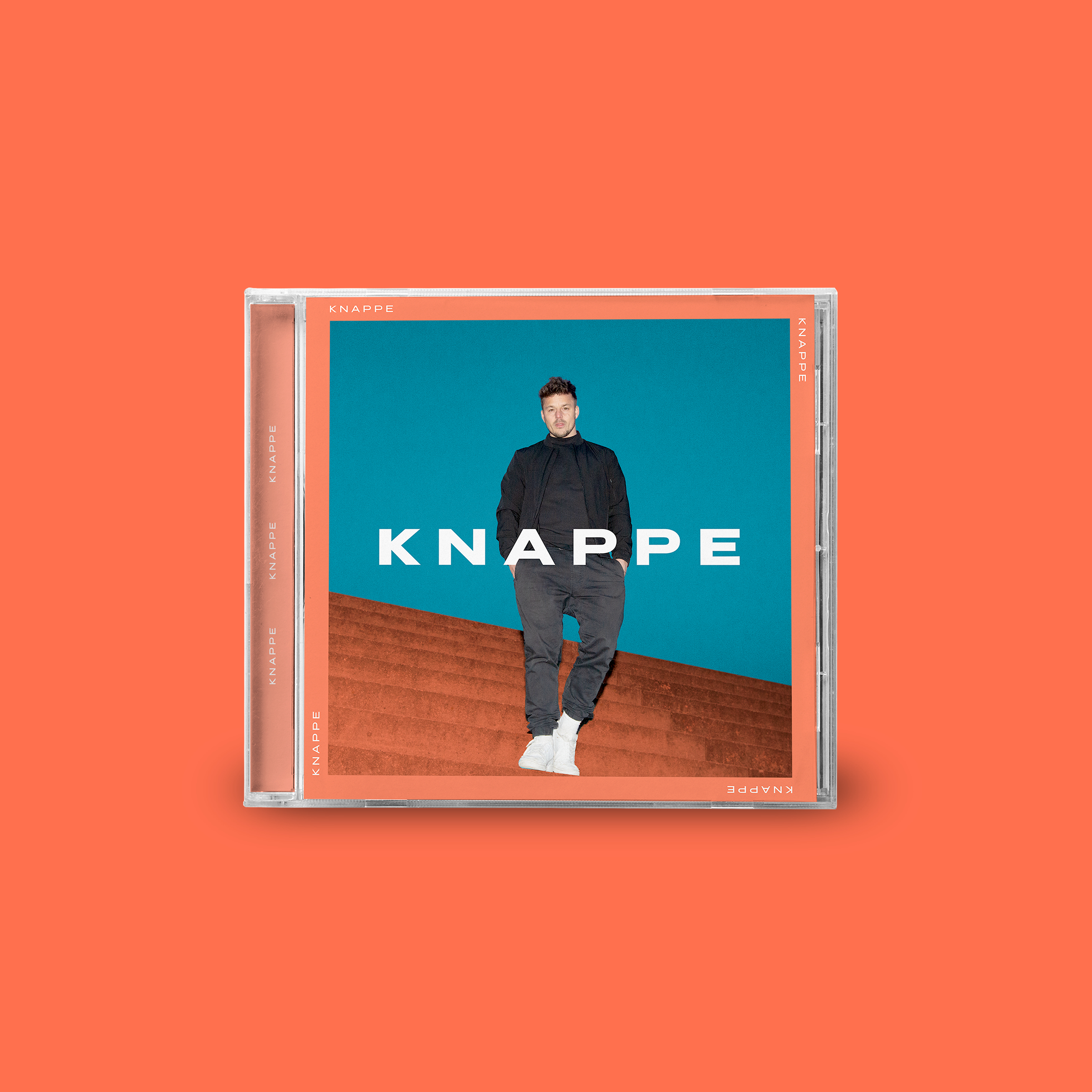 CD-Hülle mit einem Mann in schwarzer Kleidung auf türkisblauem Hintergrund mit Text.