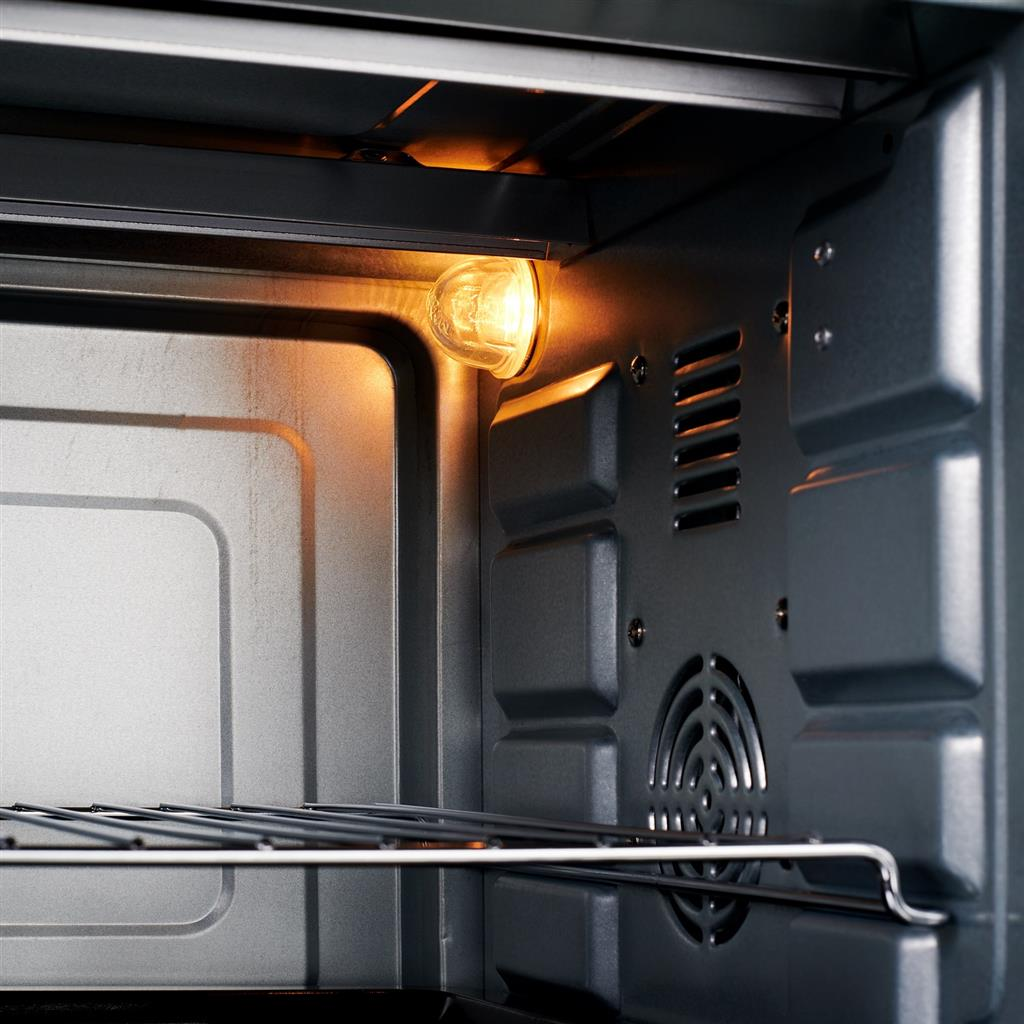 Inside of an oven with a lightbulb.