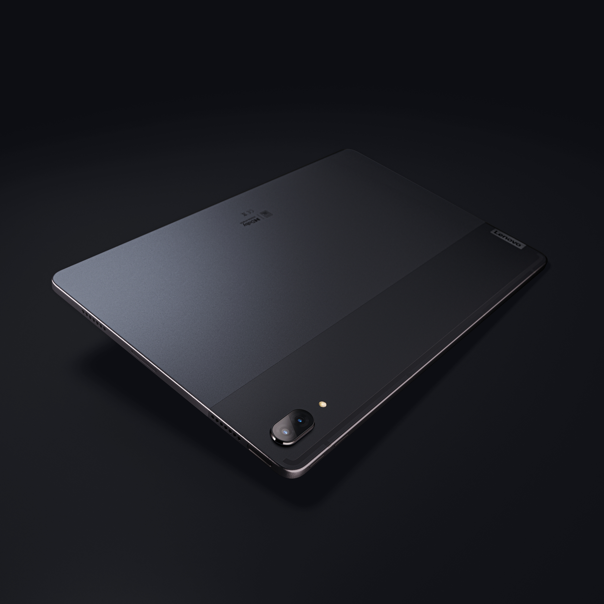 Ein Lenovo Tablet, dunkelgrau, mit zweifarbigem Rücken und Kamera. Der Bildschirm ist ausgeschaltet. Schwarzer Hintergrund.