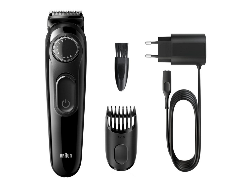 Recortadora de barba negra y accesorios dispuestos sobre una superficie blanca.