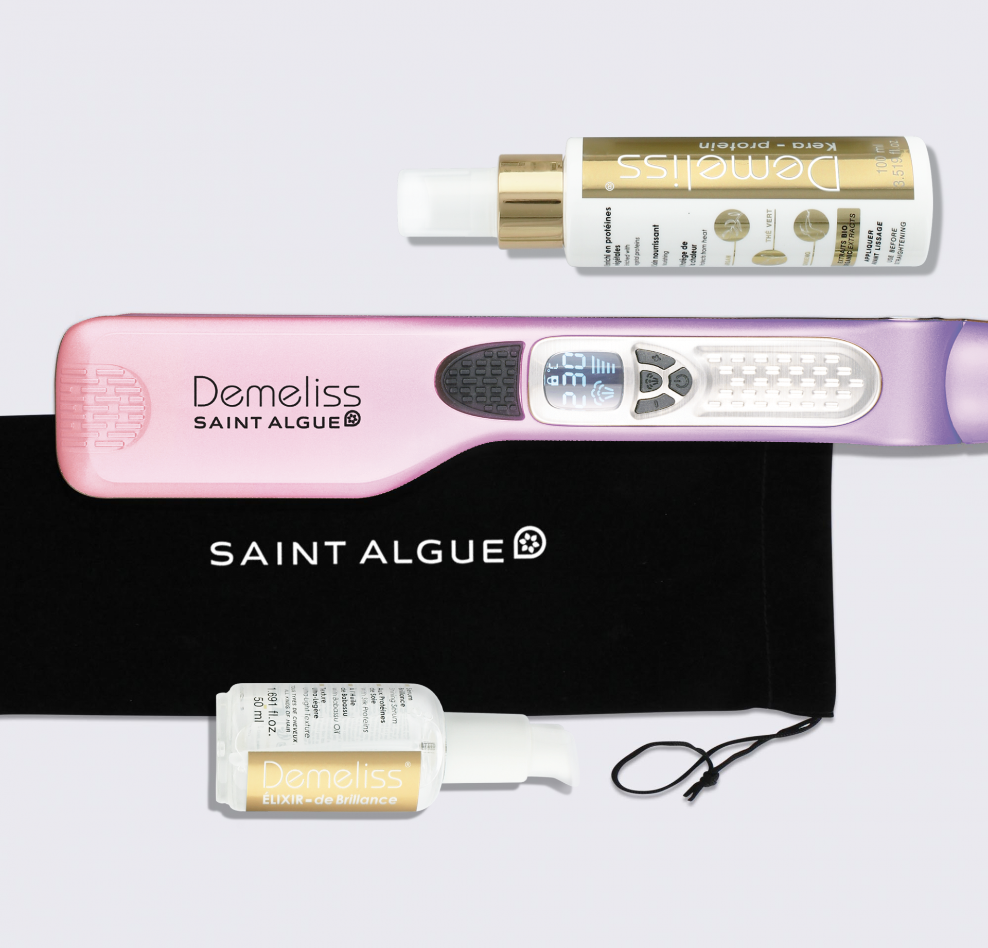 Hair care products, including a straightener, on a white surface. Black bag.