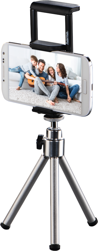 Smartphone monté sur un trépied argenté. Le téléphone affiche une photo de famille.