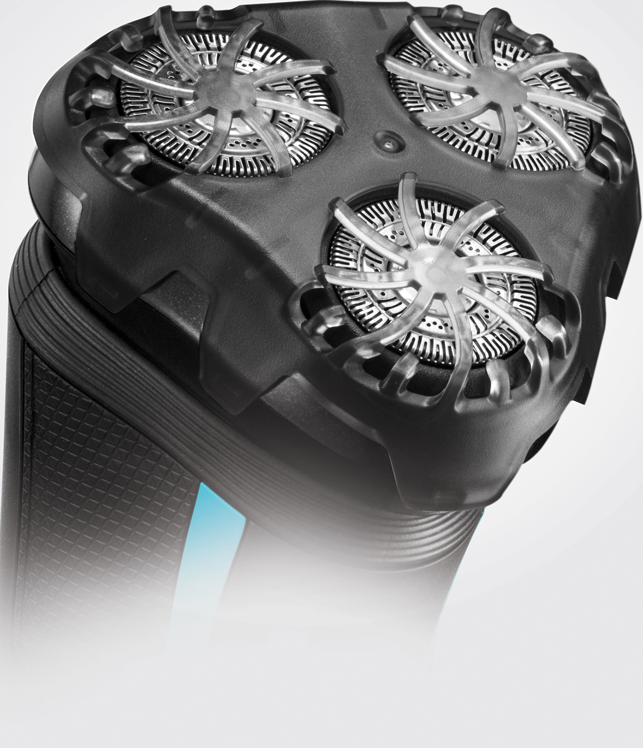 A close-up of a black electric shaver with three rotating heads.