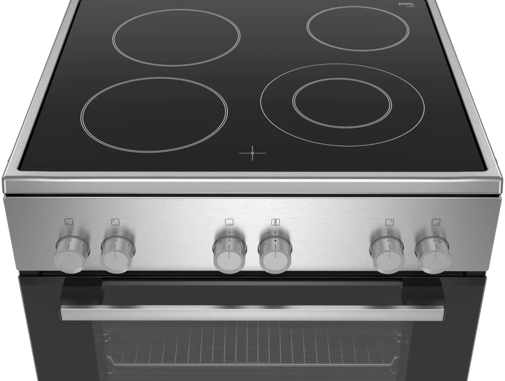 A stainless steel induction cooktop with four circular burners and control knobs.