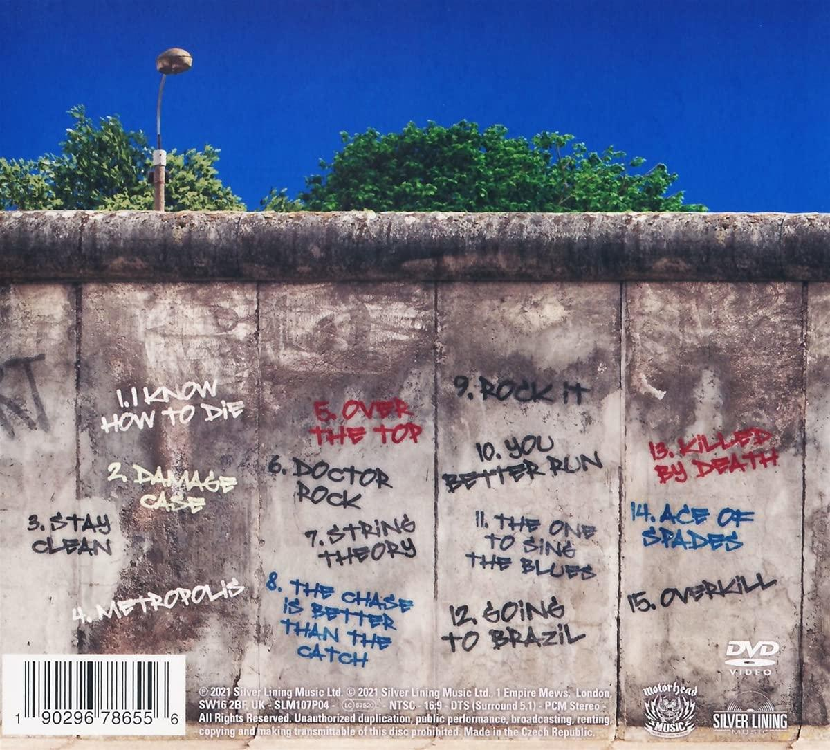 CD borító a berlini fal graffitijeivel és a dalok címeivel, kék ég háttérrel.