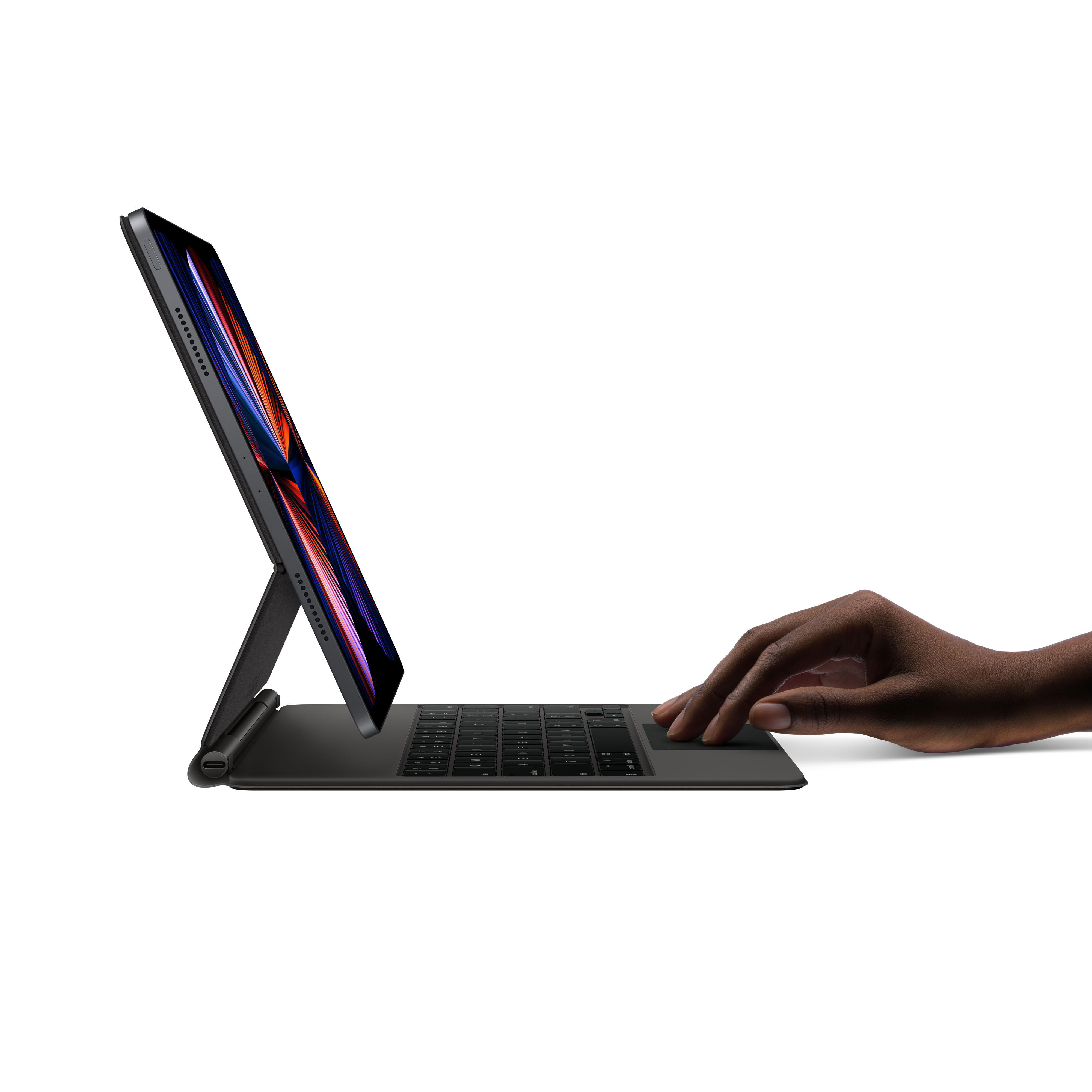 Schwarzes iPad Pro mit Tastatur, Hand berührt Bildschirm auf weißem Hintergrund.