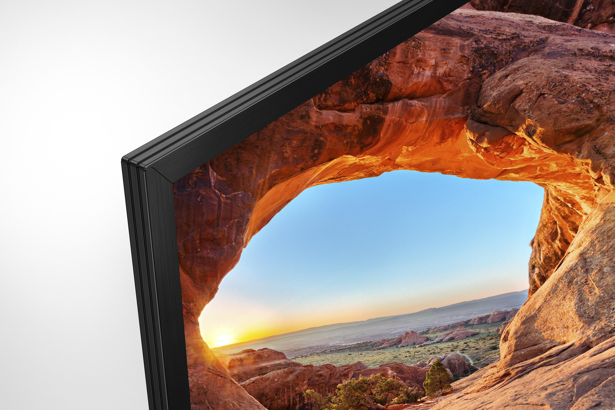 Ecke eines TV-Rahmens mit einer Wüstenlandschaft. Sonnenuntergang über dem Bogen.