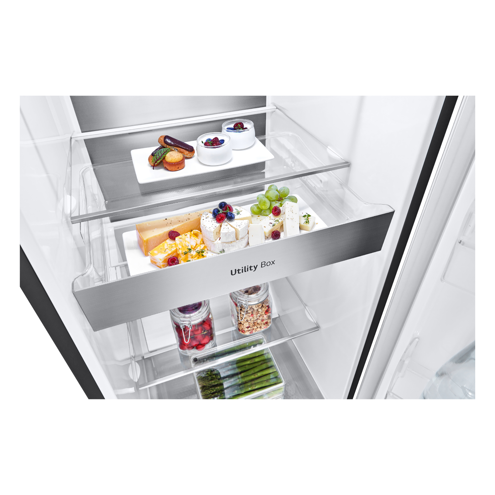 Refrigerator interior with two shelves holding food items like cheese, fruits, and snacks.