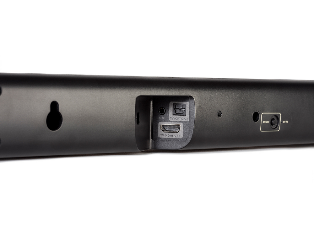 Vista trasera de barra de sonido negra con puertos AUX, HDMI y reset.