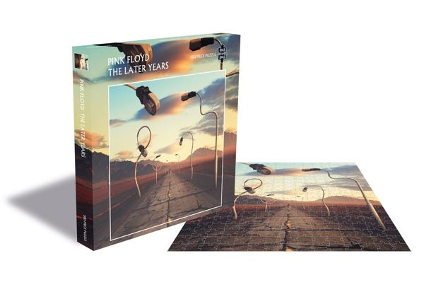 Pink Floyd kirakós doboz és kész kirakós. A doboz utcát mutat lámpaoszlopokkal. A kirakós egy fehér felületen van.
