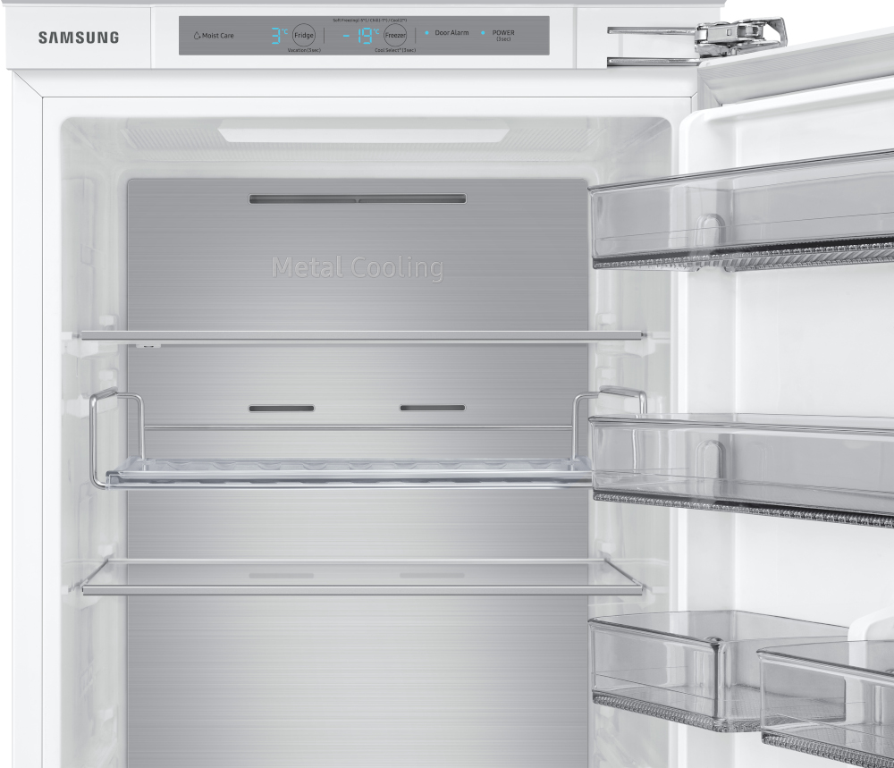 Een leeg interieur van een koelkast. Het heeft planken en laden en een metalen koelpaneel.