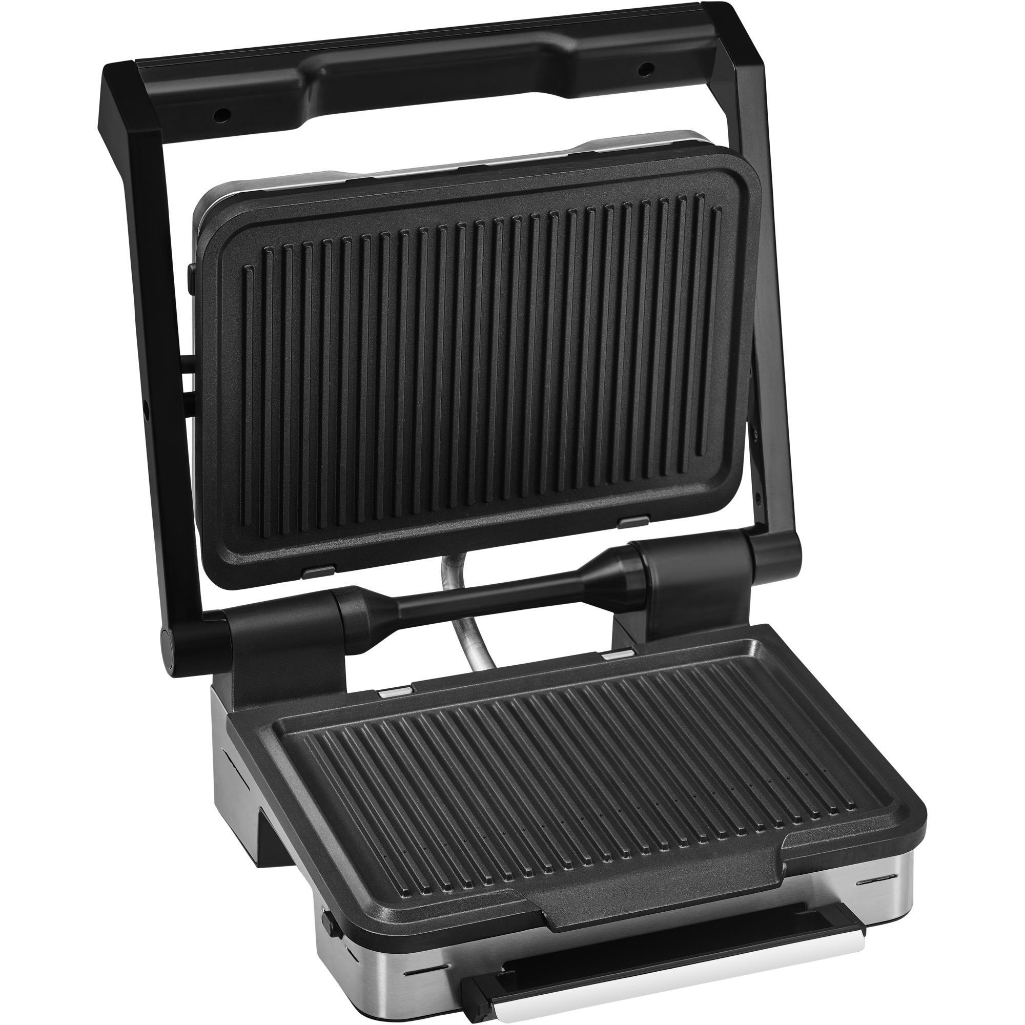 Offener schwarzer und silberner Grill mit gerippten Platten.