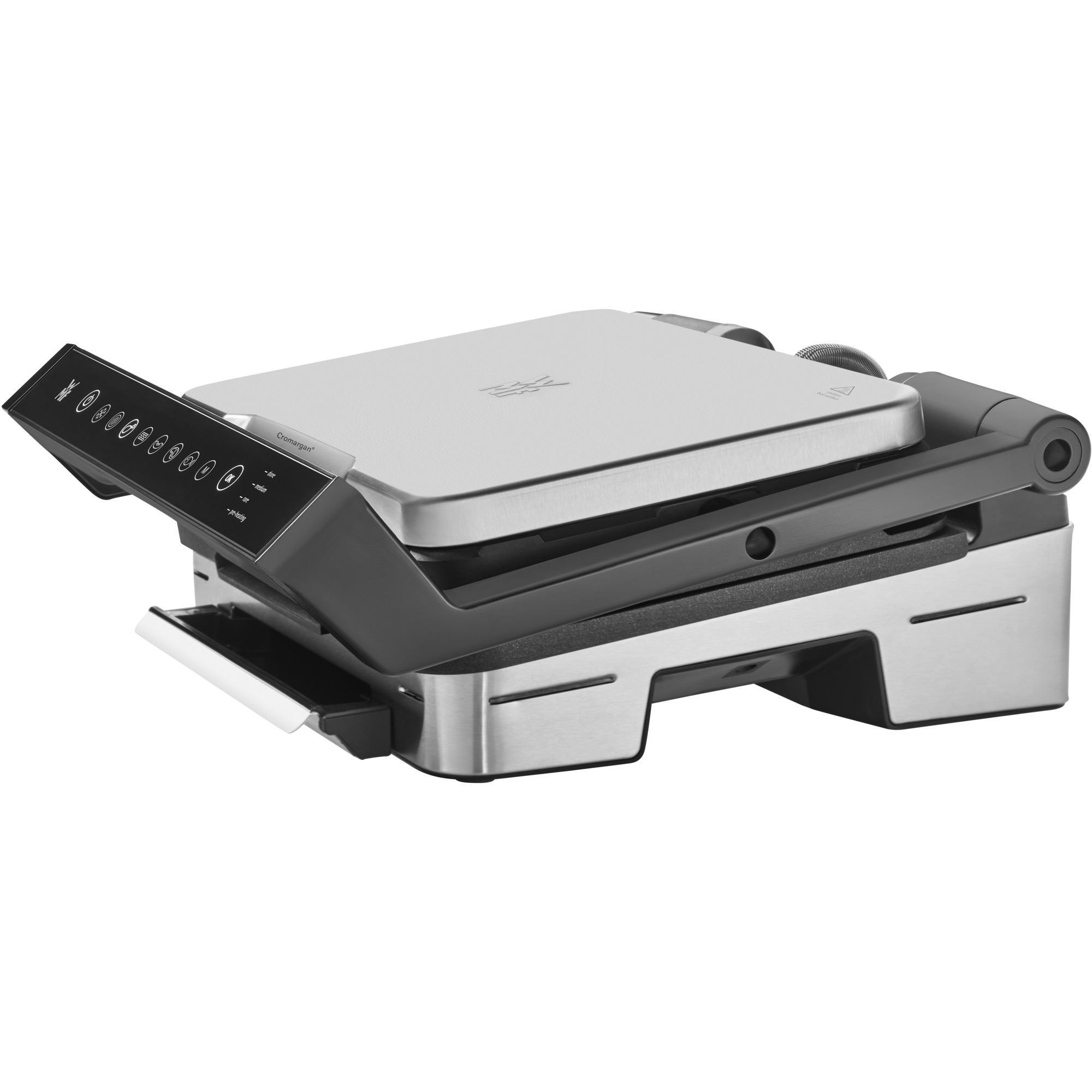 Silber-schwarzer elektrischer Indoor-Grill mit geschlossenem Deckel und Bedienfeld an der Seite. Weiße Ablage sichtbar.