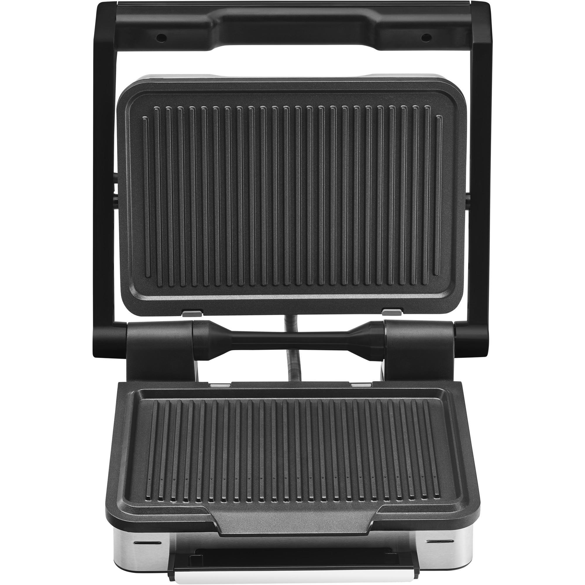 Eine offene schwarze Panini-Presse mit geriffelten Kochflächen, Draufsicht.
