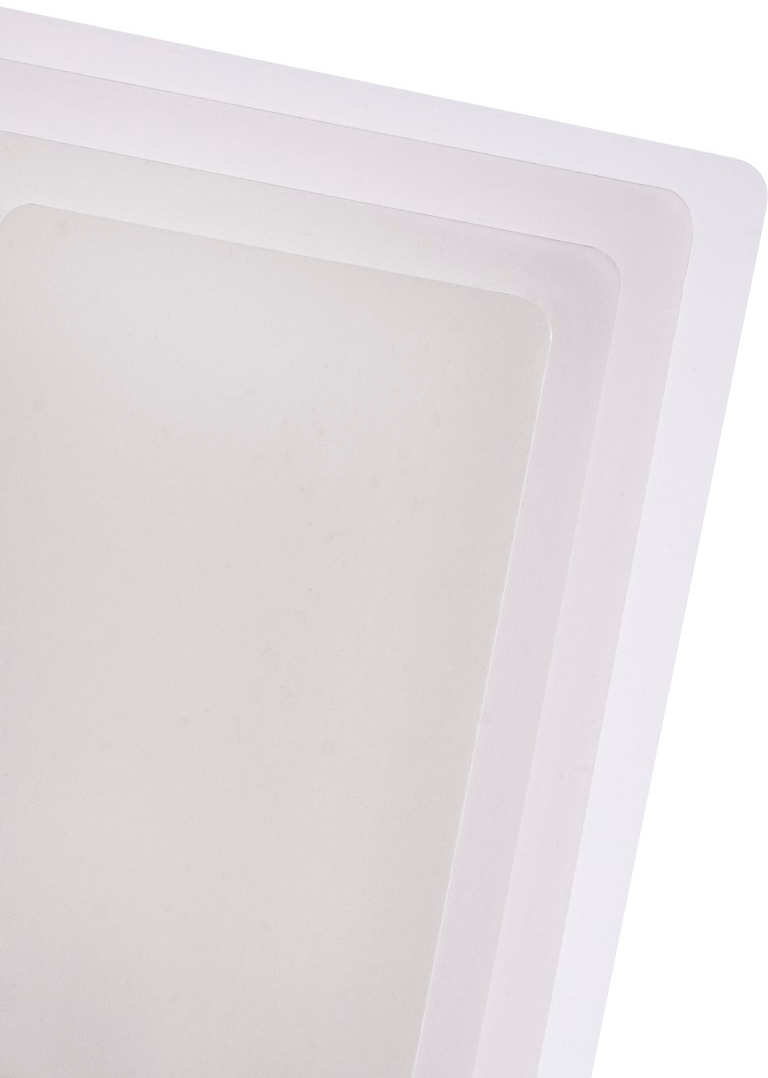 Gros plan de feuilles blanches et translucides empilées, superposées en angle.
