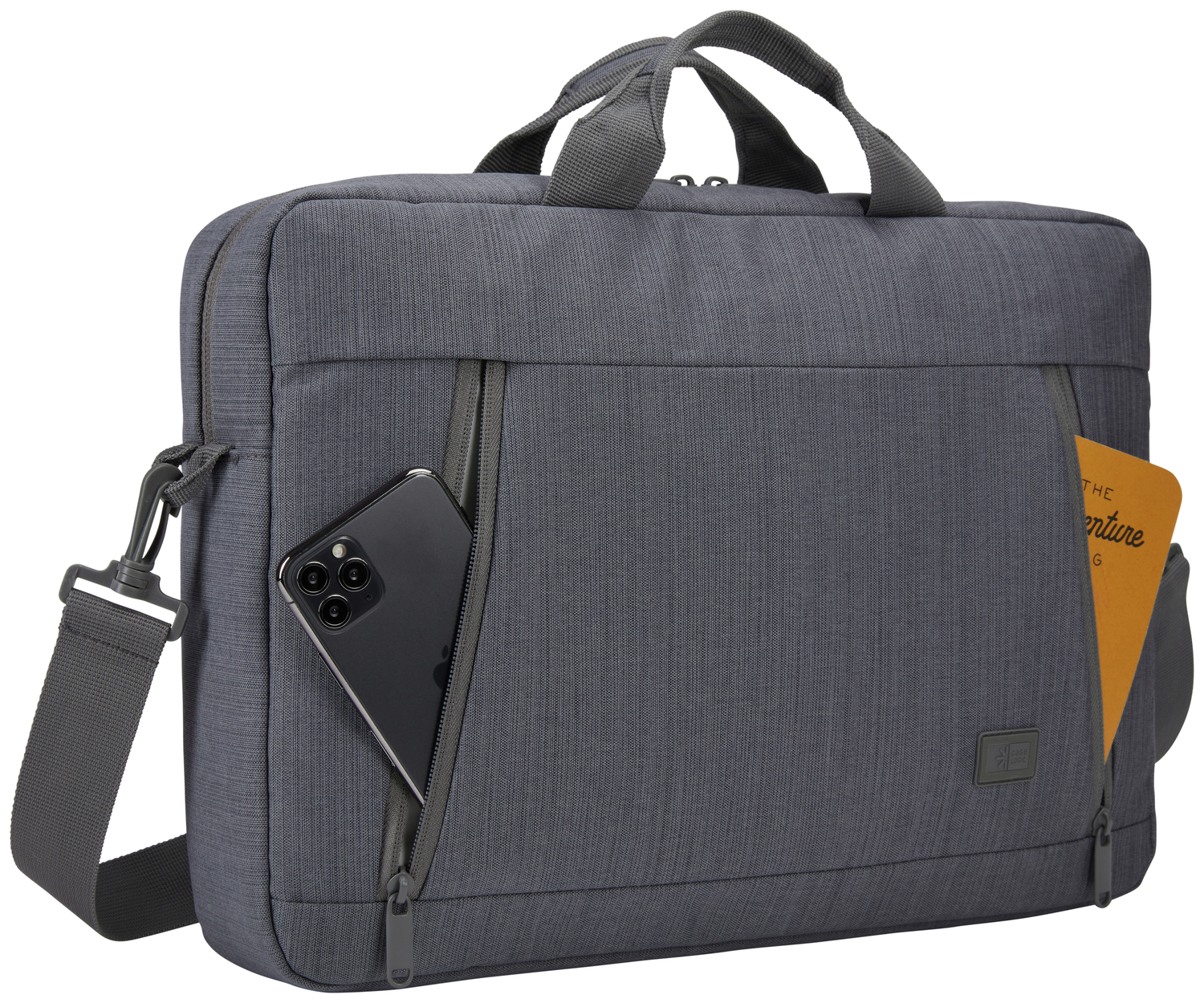 A gray briefcase with a phone in the pocket and a notebook. It has a strap.