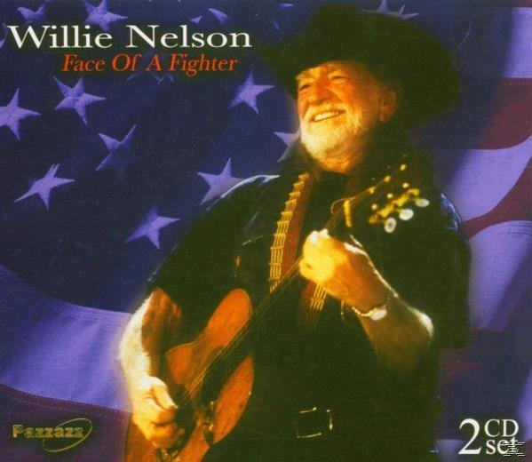 Willie Nelson gitárral, kalapban, amerikai zászló előtt.