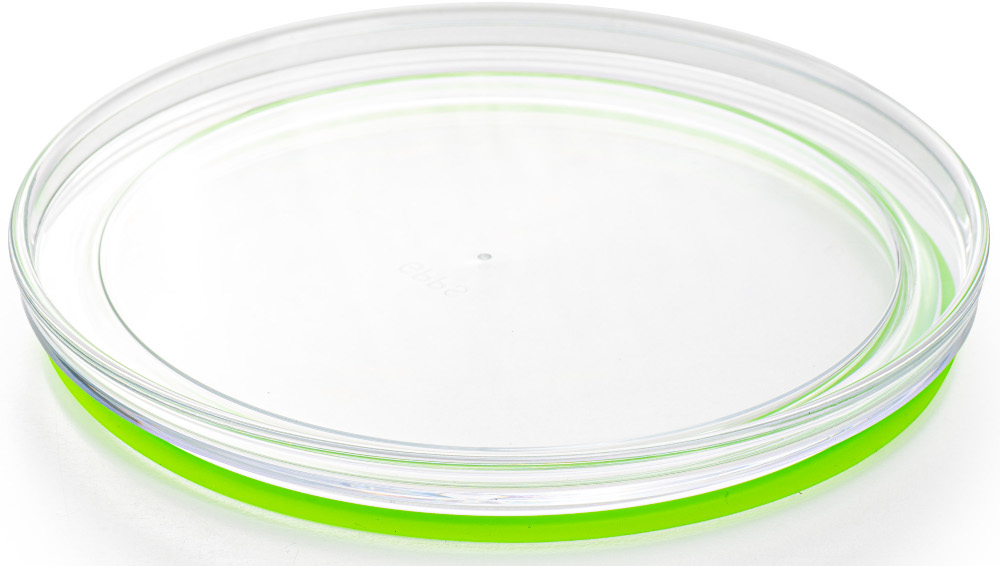 Assiette transparente et transparente avec un bord vert vif, sur une surface blanche.