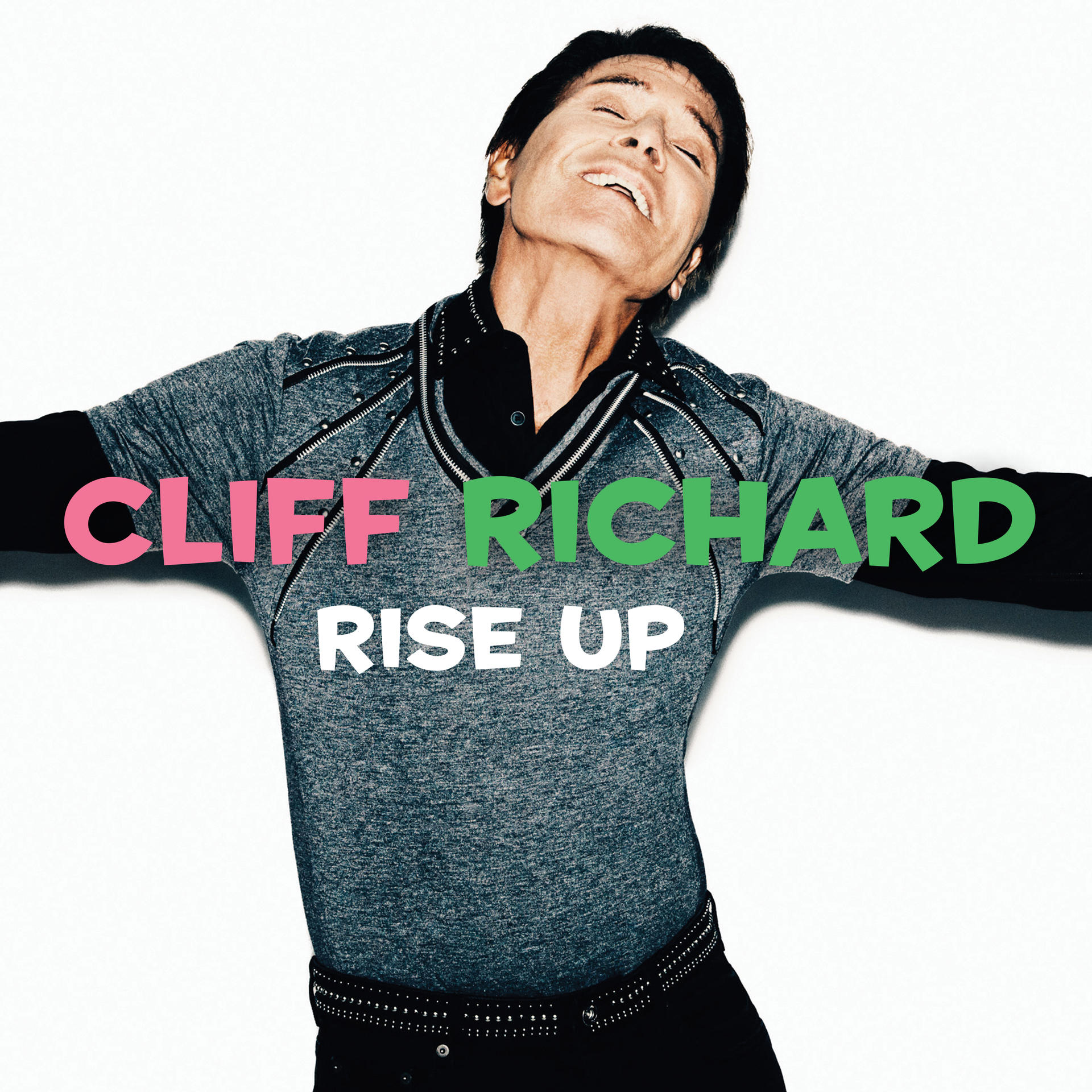 Albumcover: Cliff Richard in grauem Hemd mit offenen Armen, weißer Hintergrund, pinkfarbener und grüner Text.