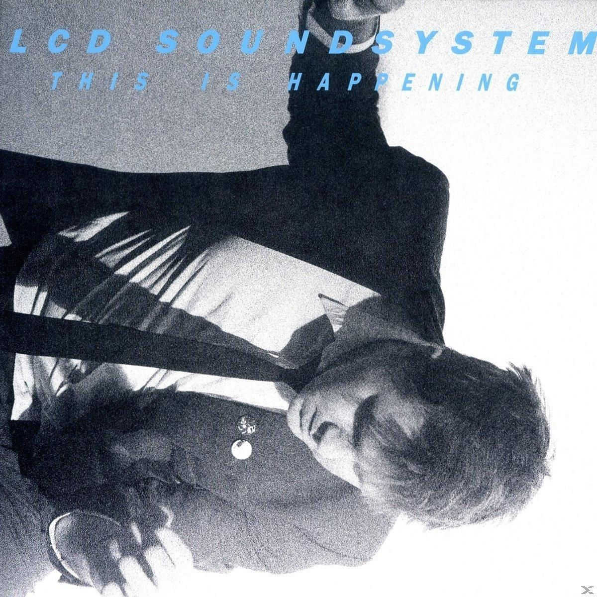 Albumborító egy fejjel lefelé lógó férfival, 'LCD Soundsystem This is Happening' szöveggel.