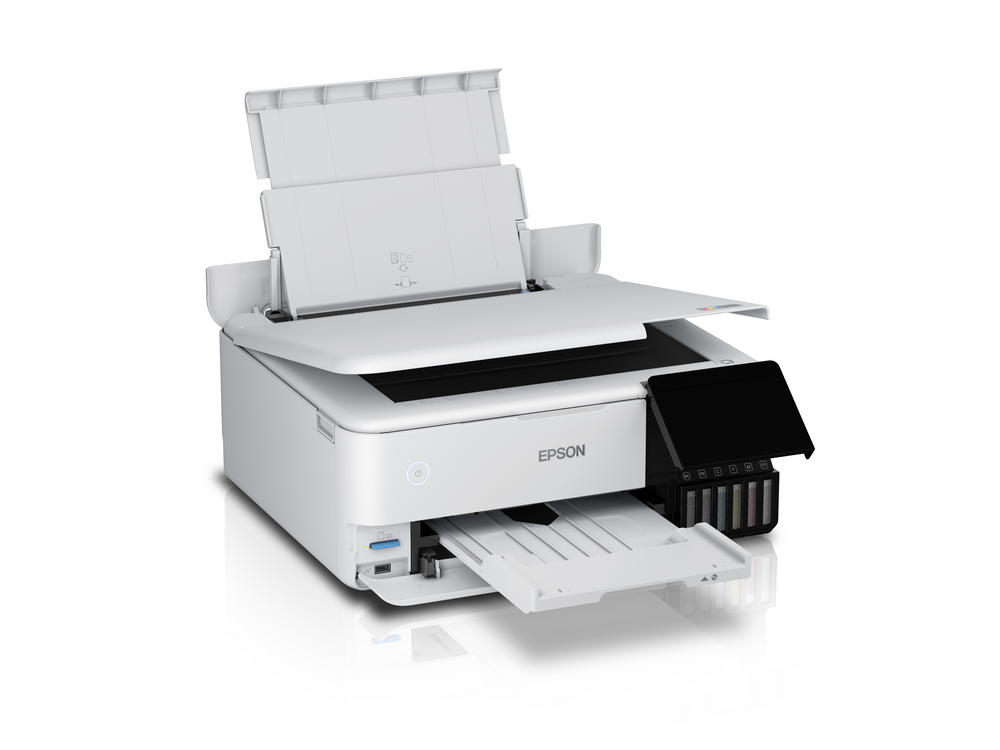 Impresora Epson blanca con cubiertas abiertas y zona de cartuchos de tinta negra.