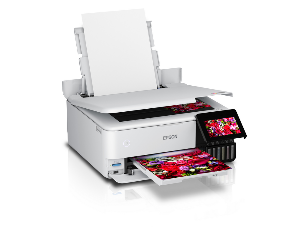Impresora Epson blanca imprimiendo una imagen floral colorida. Una pantalla táctil está en el lado derecho.