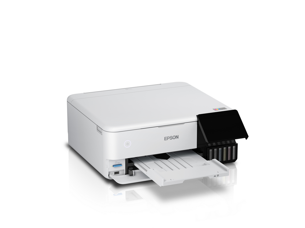 Impresora Epson blanca con bandeja abierta y compartimento de cartuchos.