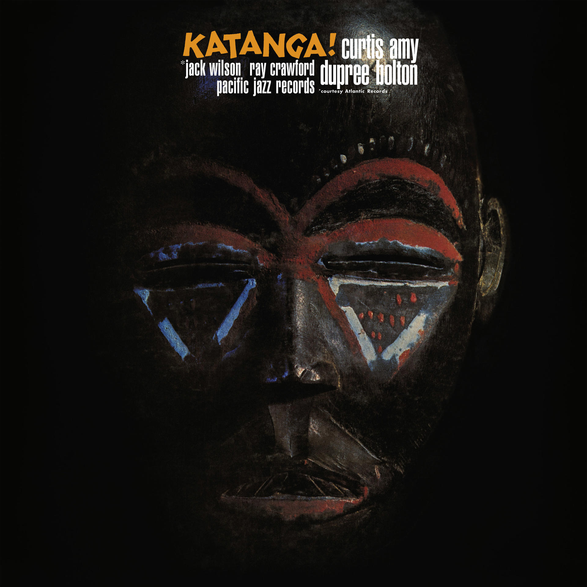 Album borító. Egy fa maszk egy arccal, az album neve 'Katanga'.