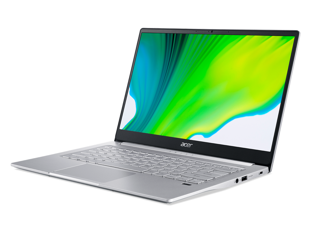 Una computadora portátil plateada está abierta sobre una mesa, mostrando una pantalla verde y amarilla.