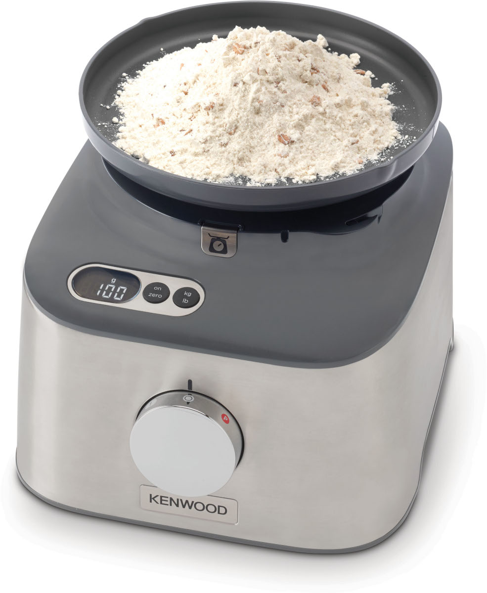 Food processor with flour on top, gray base and a dial.